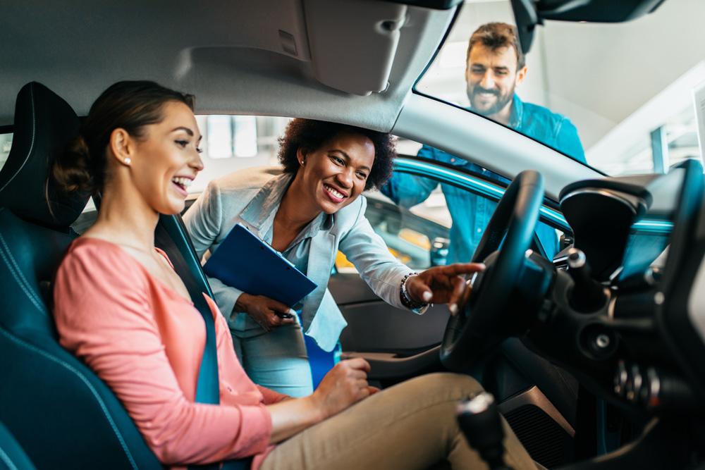 women looking at car